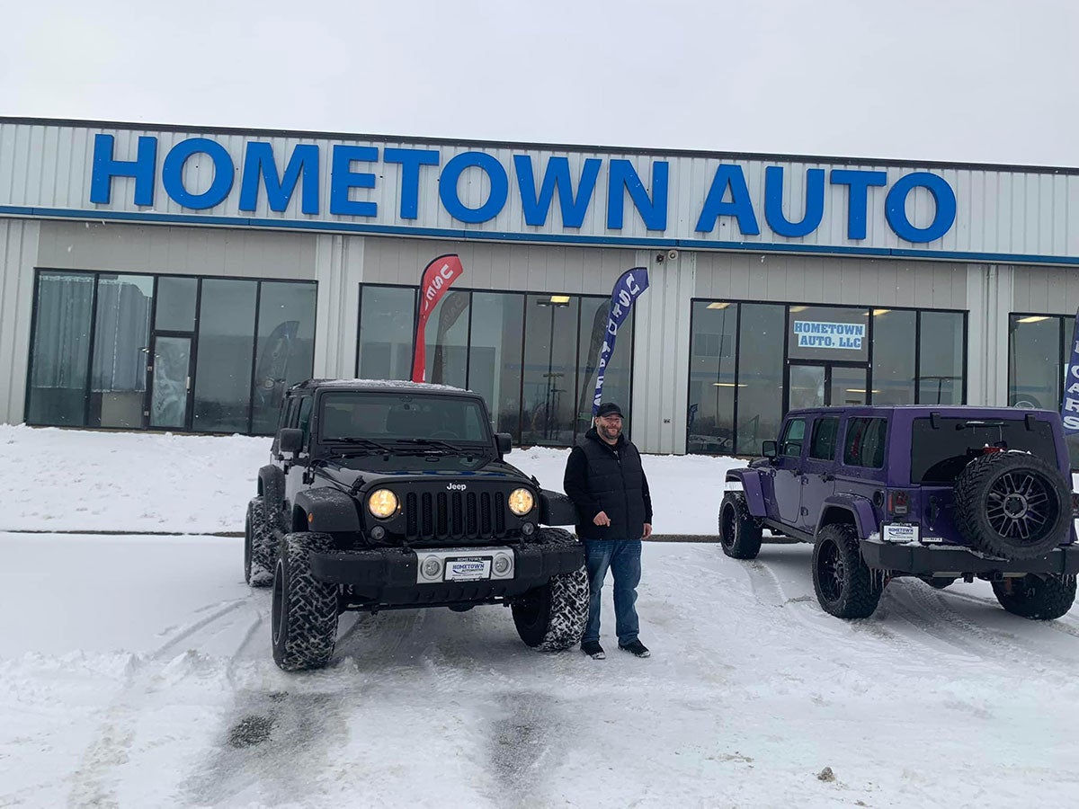 A man stands with his newly-purchased used Jeep Wrangler at our Chillicothe, OH dealership