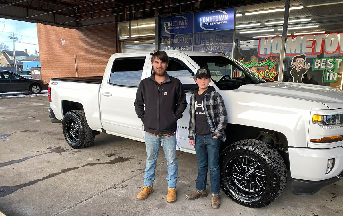 A son and his father in front of their newly-purchased used truck at our Hometown dealership
